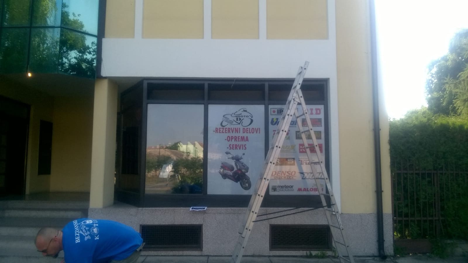 Montaža reklame i brendiranje izloga prodavnice Moto D